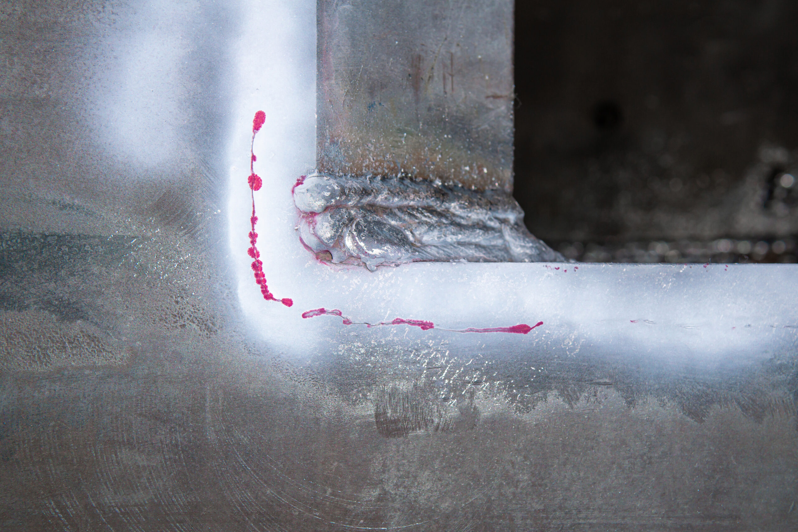 Crack on the surface of steel with Red color defect Penetrant Testing process or PT test after welding work for repair work